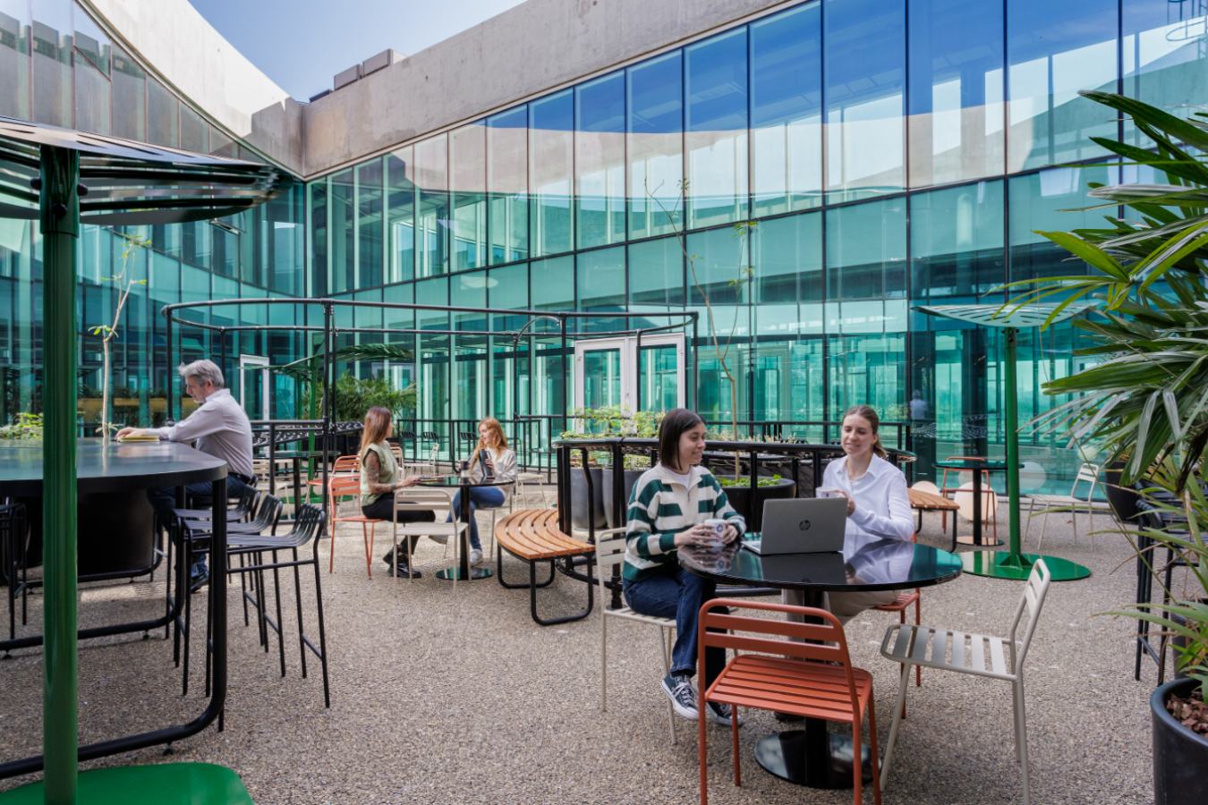 Uala Offices 2024 - Outdoor corporate terrace with glass facade and casual meeting tables - Contract Workplaces.jpg